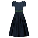 Navy blue dress with a green belt on a white background