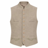 A light beige traditional German waistcoat (Mantel) with a mandarin collar, gold-tone buttons, and subtle green embroidery on the pockets and lower front, shown against a plain white background.
