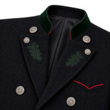 Close-up of a dark wool coat with a green velvet peak collar, silver decorative buttons, green embroidered leaf motifs on the lapels, and red piping detail.