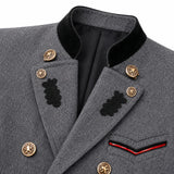 Close-up of a gray wool military-style jacket with black velvet collar, black embroidered leaf details, gold buttons, and a red and black chevron pocket trim.