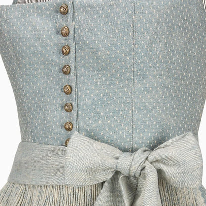 Close-up of a light blue dress with buttons and a bow detail.