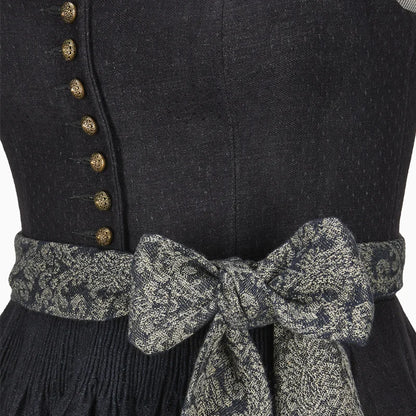 Black dress with gold buttons and a patterned belt on a plain background
