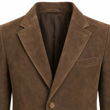 A close-up of a brown suede or nubuck blazer jacket, showing the texture of the fabric, the notch lapels, and a single button closure against a white background.
