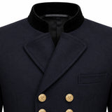 Close-up of a dark navy double-breasted coat with a black velvet collar and gold buttons, shown on a white background.