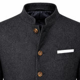 Close-up of a dark gray textured wool jacket with a mandarin collar, three brown buttons, and a white pocket square in a chest pocket.