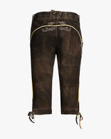 Brown leather pants with decorative elements on a white background