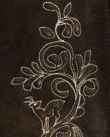 Decorative floral embroidery on a dark fabric background