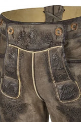 Brown leather pants with intricate designs and buttons on a beige background
