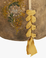Brown fabric with embroidered floral design and yellow tassels on a white background