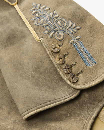 Close-up of a brown leather vest with decorative embroidery and buttons.