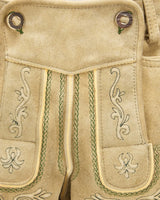 Close-up of beige fabric with intricate green embroidery