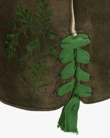 Green embroidered design on a brown fabric with a tassel
