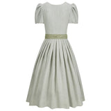 Light gray dress with a green belt on a white background