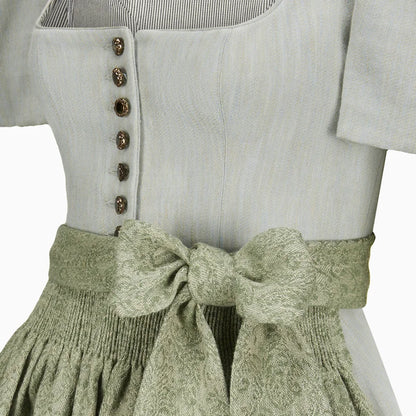 Light gray top with button details and a green textured skirt on a white background