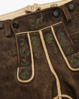 Brown leather pants with green embroidery and buttons, featuring a visible brand logo.