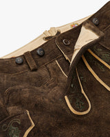 Close-up of brown leather pants with decorative stitching and buttons on a white background