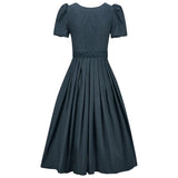 Navy polka dot dress on a white background