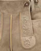 Close-up of brown leather pants with intricate stitching and a embroidered design.