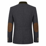 A dark gray textured wool-blend blazer shown from the back, featuring brown suede elbow patches and a contrasting dark olive green collar.
