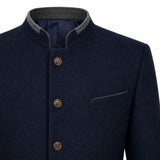 Close-up of a dark navy wool jacket with a mandarin collar, brown buttons, and a gray inner collar lining, shown on a white background.