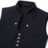 Close-up of a dark navy wool vest with a high dark green corduroy collar, silver-tone snap buttons, and welt pockets on a white background.