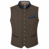 A men's waistcoat vest in textured brown wool with dark navy blue trim on the collar, pocket flaps, and button placket, featuring a matching patterned blue pocket square.