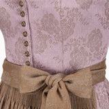 Close-up of a traditional outfit with a patterned top and brown belt.