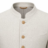 Close-up of a light beige textured jacket with a mandarin collar, three wooden buttons, and a gingham lining visible inside the collar.
