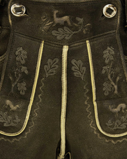 Dark fabric with embroidered patterns and decorative buttons