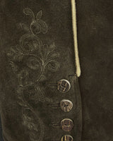 Close-up of a brown suede jacket with floral embroidery and buttons.