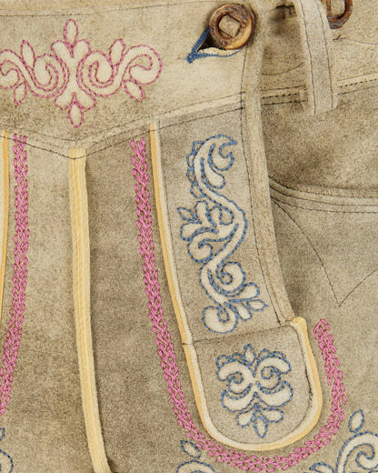 Close-up of traditional Bavarian lederhosen with intricate embroidery.