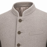Close-up of a light gray textured wool jacket with a mandarin collar, three dark metal buttons, and a welt pocket on the chest.