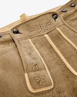 Close-up of a brown leather jacket with intricate stitching and decorative patterns.