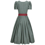 Green checkered dress with a red belt on a white background