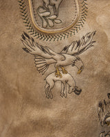 Embroidered design of a bird on a textured brown leather surface
