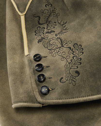 Close-up of a brown fabric with embroidered design and buttons.