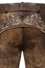 Brown leather pants with intricate white embroidery on a white background