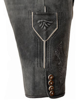 Close-up of gray leather pants with decorative stitching and buttons on a white background