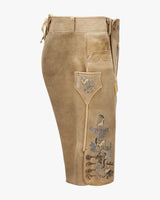 Brown leather pants with embroidered designs on a white background
