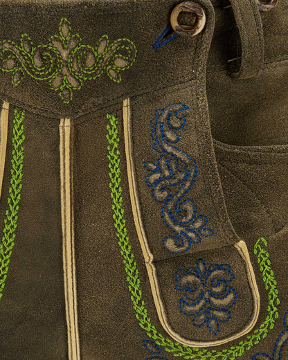 Brown fabric with green and blue embroidery details
