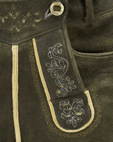 Close-up of dark brown leather with intricate white embroidery on a strap.