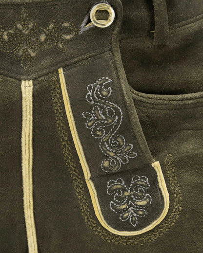 Close-up of dark brown leather with intricate white embroidery on a strap.